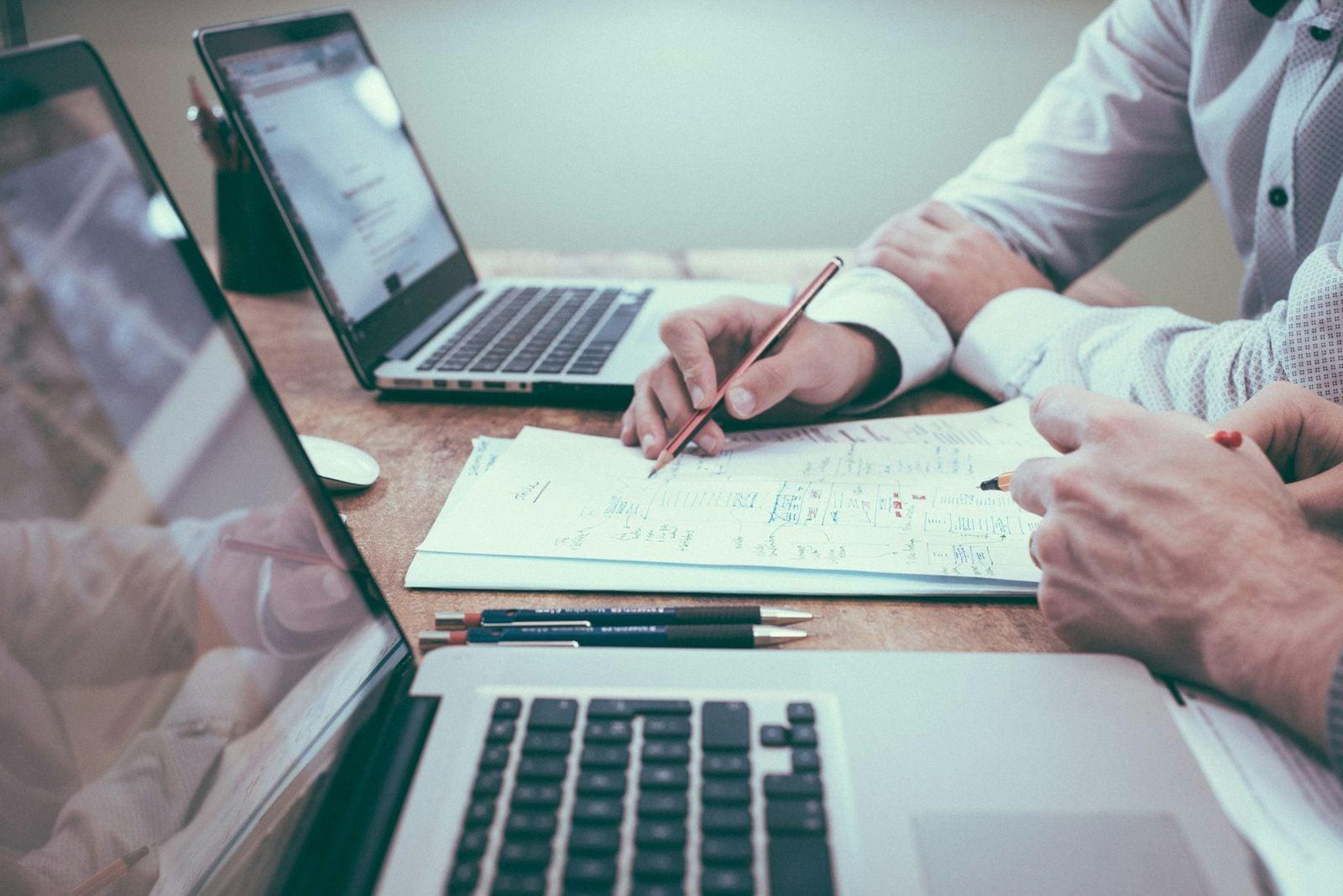 Business professionals reviewing governance documents at a conference table